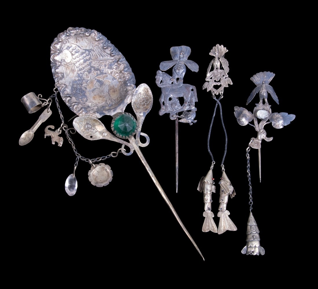 (4) ANDEAN SILVER SHAWL PINS: (4) ANDEAN SILVER SHAWL PINS A group of folk silver ornaments including shawl pins, hanging fish-form elements, birds, and figural motifs. Likely Andean or South American in origin, with repouss? and