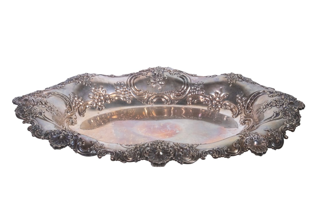 TIFFANY & CO. STERLING OVAL FOOTED CENTER BOWL: TIFFANY & CO. STERLING OVAL FOOTED CENTER BOWL Circa 1900 American Silver Serving Bowl, with rolled rim, ornate repousse floral decoration, shell and scroll motif rim, set on paw feet, the base