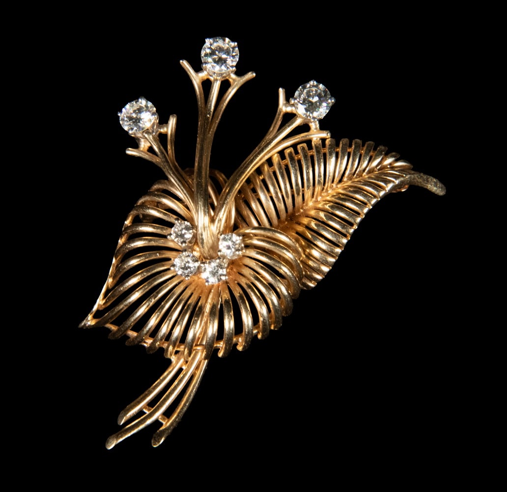 DAN FRERE VINTAGE 14K GOLD AND DIAMOND FLOWER SPRAY BROOCH: DAN FRERE VINTAGE 14K GOLD AND DIAMOND FLOWER SPRAY BROOCH A sculptural 14K yellow gold flower spray brooch by Dan Frere, designed with sweeping openwork foliate forms and radiating wirework elements