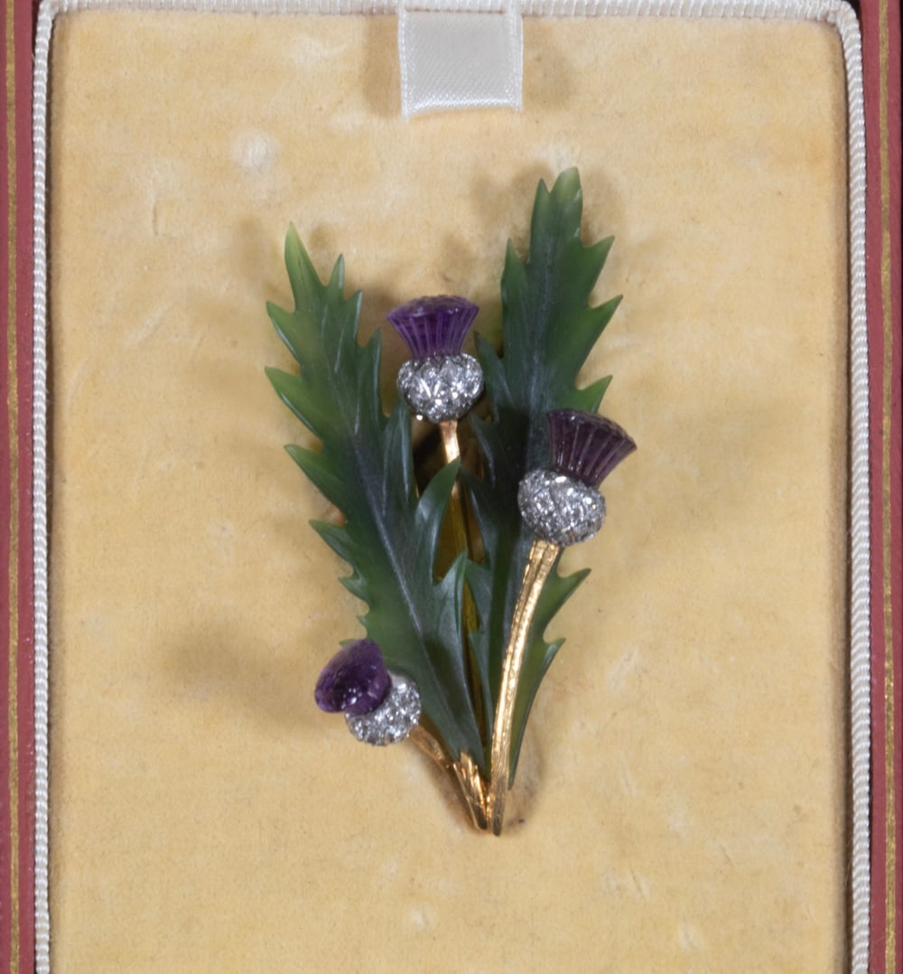 CARRINGTON & CO. 18K GOLD, PLATINUM, JADE, AMETHYST AND DIAMOND THISTLE BROOCH: 14K GOLD AND DIAMOND RING Set with one emerald-cut diamond weighing approximately 1.00 carat, estimated H-I-J color, VS1 clarity (as observed in mounting), flanked by (2) trapezoid-cut diamonds