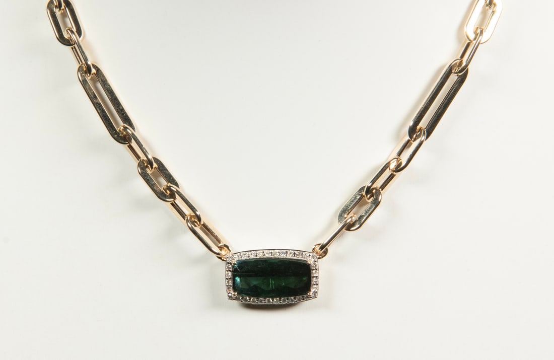 14K GOLD TOURMALINE AND DIAMOND NECKLACE: 14K GOLD TOURMALINE AND DIAMOND NECKLACE A 14K yellow gold necklace centered by a rectangular cushion brilliant-cut natural green tourmaline weighing approximately 6.46 carats, framed by (32) round br