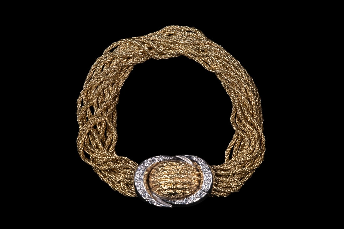 18K GOLD MULTI-STRAND DIAMOND BRACELET: 18K GOLD MULTI-STRAND DIAMOND BRACELET An elegant 18K yellow gold bracelet composed of (13) twisted rope-form strands terminating in a concealed clasp design accented with white gold and (16) round di