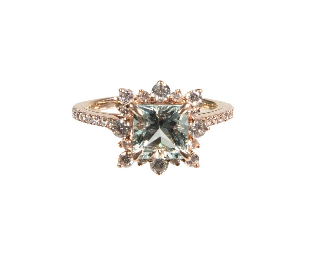 18K ROSE GOLD AQUAMARINE AND DIAMOND RING: 18K ROSE GOLD AQUAMARINE AND DIAMOND RING An 18K rose gold ring centered by a princess-cut aquamarine measuring approximately 7.11 x 7.11 mm, framed by (16) round diamonds in a snowflake-style halo,