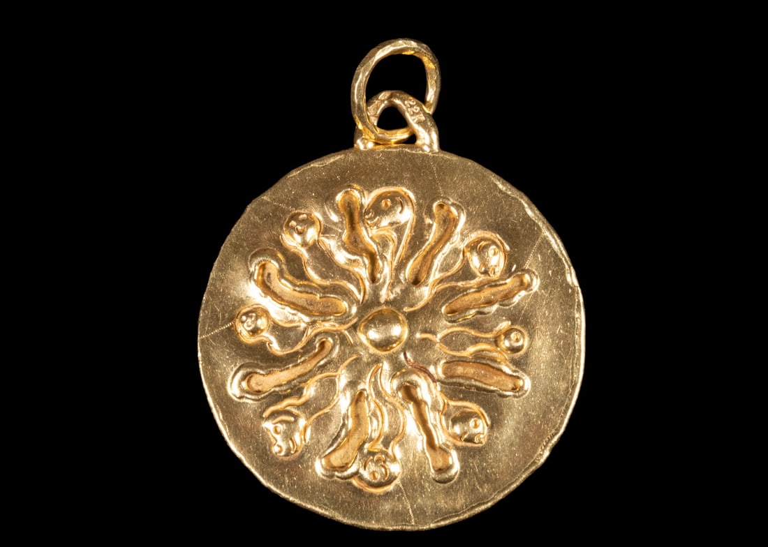 VINTAGE JEAN MAHIE 22K GOLD PENDANT: VINTAGE JEAN MAHIE 22K GOLD PENDANT Handcrafted 22K yellow gold pendant of circular form, decorated with a radiating figural and abstract motif in relief, featuring an irregular hand-finished edge, te