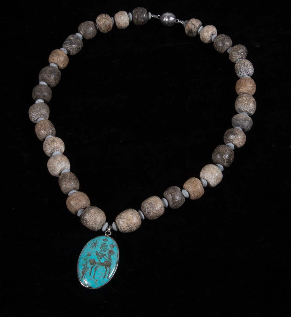 ELLEN WINDEMUTH ROMAN TURQUOISE INTAGLIO PENDANT NECKLACE: ELLEN WINDEMUTH ROMAN TURQUOISE INTAGLIO PENDANT NECKLACE A studio jewelry necklace by Ellen Windemuth, composed of fossilized Pleistocene dinosaur bone beads, serpentine spacers, and an ancient