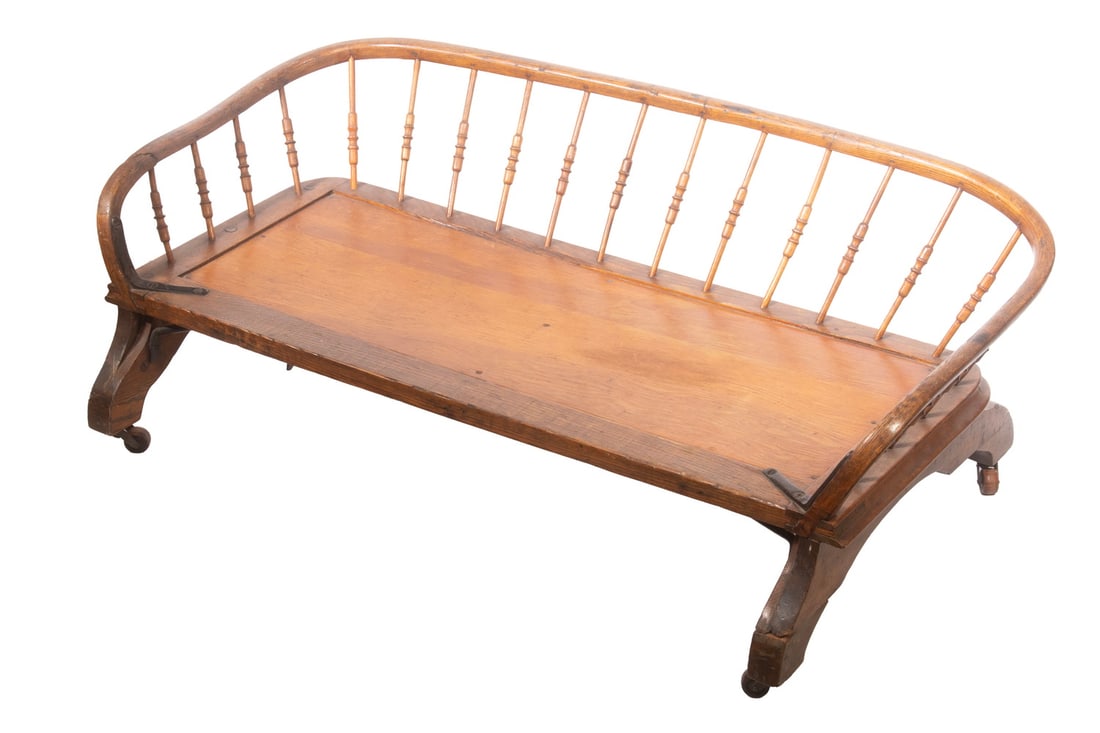 BUCKBOARD WAGON SEAT AS FOOT REST (OR DOG BED): BUCKBOARD WAGON SEAT AS FOOT REST (OR DOG BED) Low Bench with bent oak and turned spindle gallery, on yoke ends with small metal casters, seat plate replaced with thin plywood stained to match. OS: