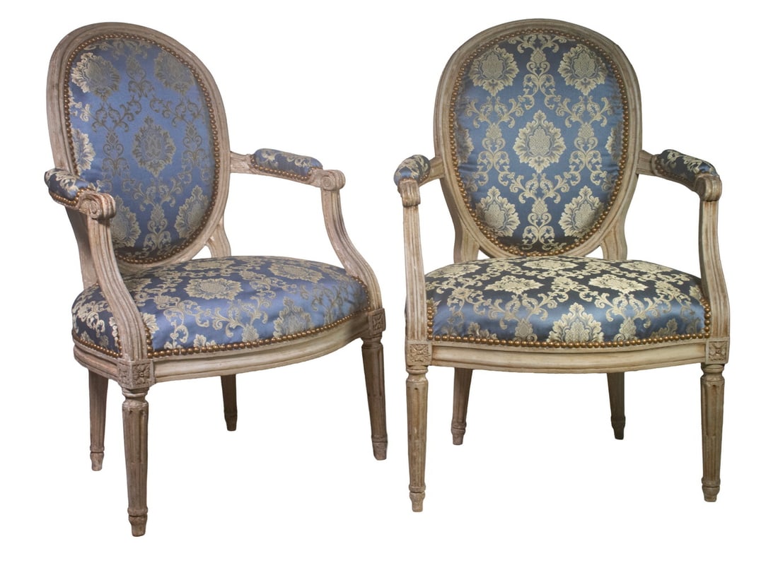 PR LOUIS XVI STYLE ARMCHAIRS: PR LOUIS XVI STYLE ARMCHAIRS Pair of 19th c. Fauteuils, with grey painted frames, blue satin fabric upholstery and brass tacks. With oval shaped back, carved arms with scrolled knuckles, set on round 