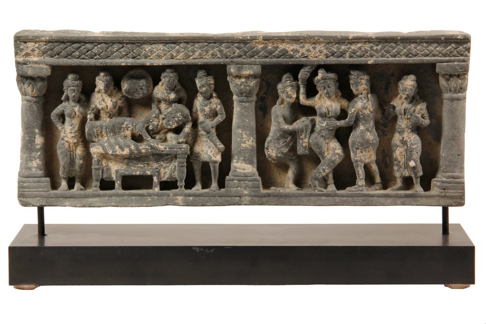 ANCIENT BUDDHIST FRIEZE - Birth of Buddha, in deep: ANCIENT BUDDHIST FRIEZE - Birth of Buddha, in deep relief, two panels with architectural framing, in grey schist, from Gandara Pakistan, circa 200-300 AD. On custom museum stand. Includes COA from Sin