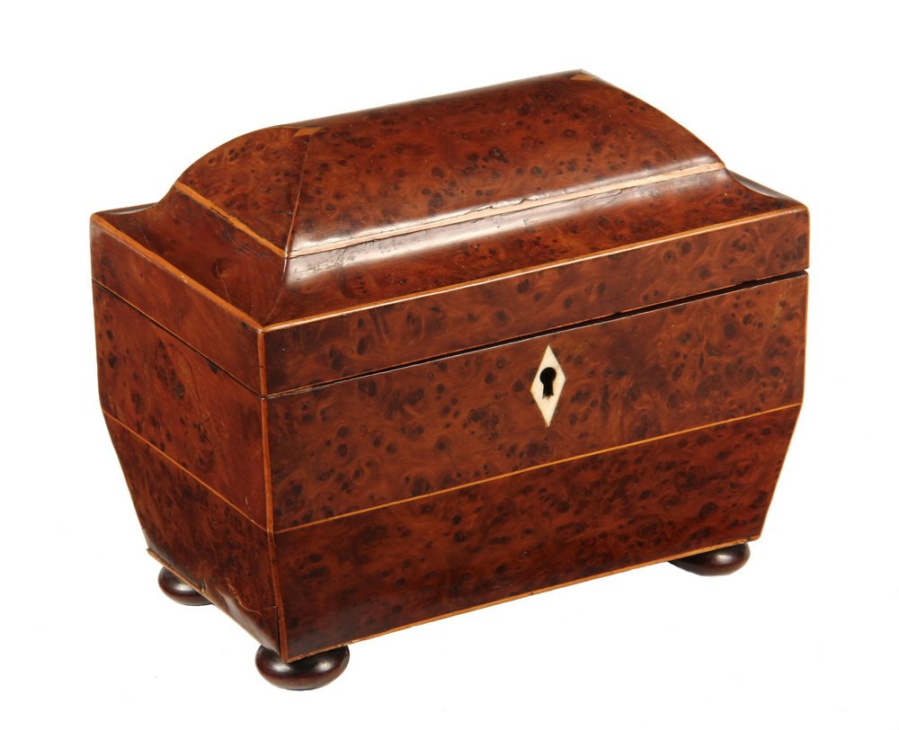 REGENCY TEA CADDY - Sarcophagus Form Caddy with domed: REGENCY TEA CADDY - Sarcophagus Form Caddy with domed lid, in burl yew-wood, boxwood string inlay, diamond ivory escutcheon with key, on bun feet; partitioned interior with covers, upholstered lid. 6 