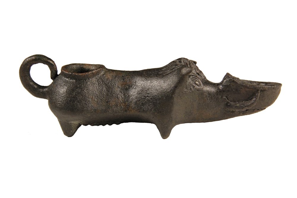 ROMAN OR BYZANTINE BRONZE LAMP - Small Oil Lamp in the: ROMAN OR BYZANTINE BRONZE LAMP - Small Oil Lamp in the form of a wild sow, the font supported by her tusks with nostrils above, curled ears, coiled tail as finger loop, evident teats, small legs. 3rd