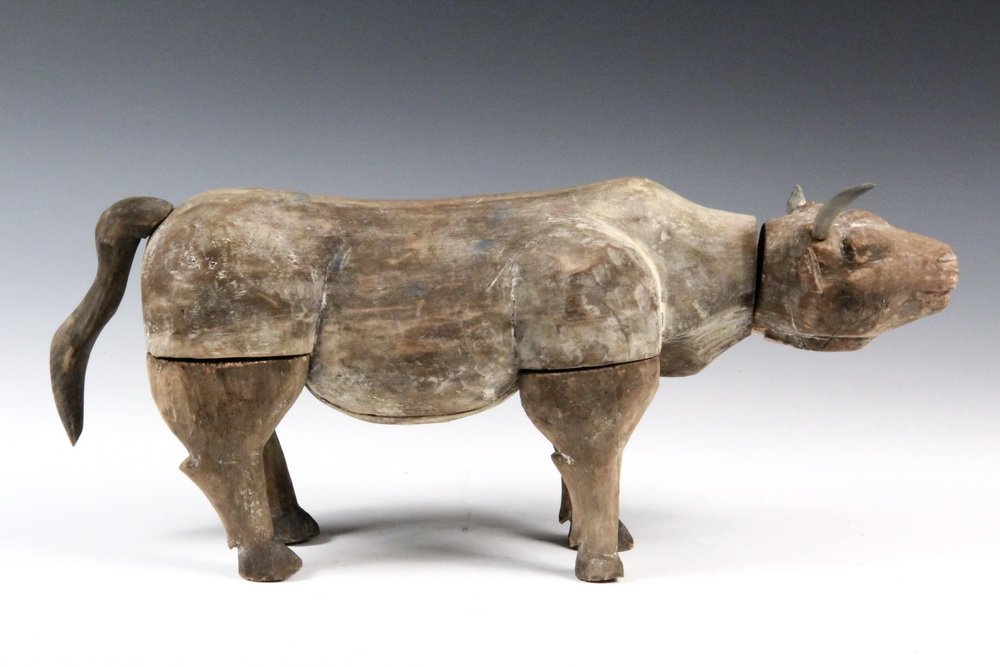 ANCIENT CHINESE WOOD CARVING - Replica of a Han Dynasty: ANCIENT CHINESE WOOD CARVING - Replica of a Han Dynasty Figure of an Ox, wood with traces of paint.6 1/4" tall (15.9 cm) x 12" long (30.5 cm). Good condition, ears, horn and tail not original. From th