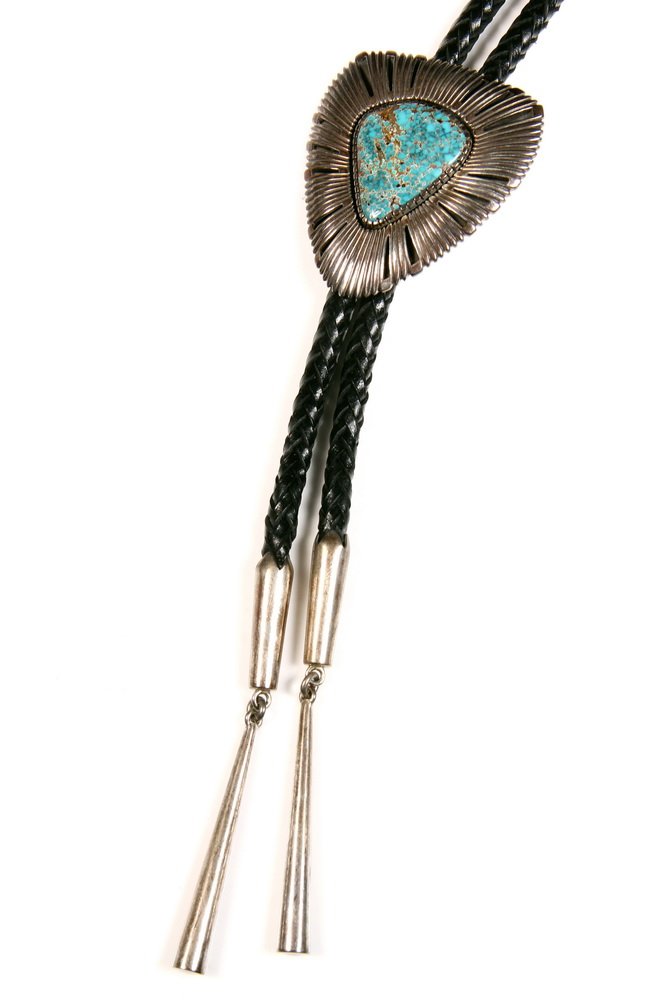 NATIVE AMERICAN BOLO - Native American Sterling and: NATIVE AMERICAN BOLO - Native American Sterling and Turquoise Bolo Tie by Navajo master silversmith Boyd Tsosie, with black woven leather and sterling end caps with drops. Bolo has triangular shaped p