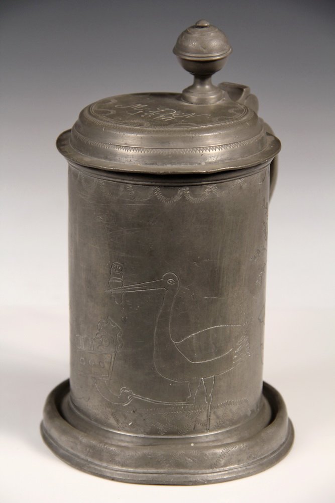 1814 DATED PEWTER FLAGON - Date & 'MDN' monogram on: 1814 DATED PEWTER FLAGON - Date & 'MDN' monogram on knopped lid, needle engraved image of stork delivering baby to cradle that is already full, flanked by trees. The bird is rocking the cradle with on
