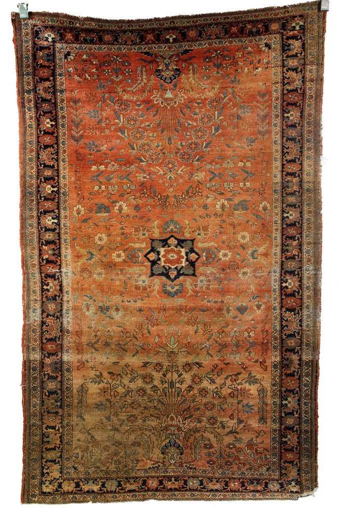 SAROUK RUG - 4'1" x 6'8" - West Persia, early 20th c,: SAROUK RUG - 4'1" x 6'8" - West Persia, early 20th c, small navy blue rosette medallion set on a soft light terra cotta field, decorated with vines and flowers in sky blue, rust, tan and ivory. Navy b