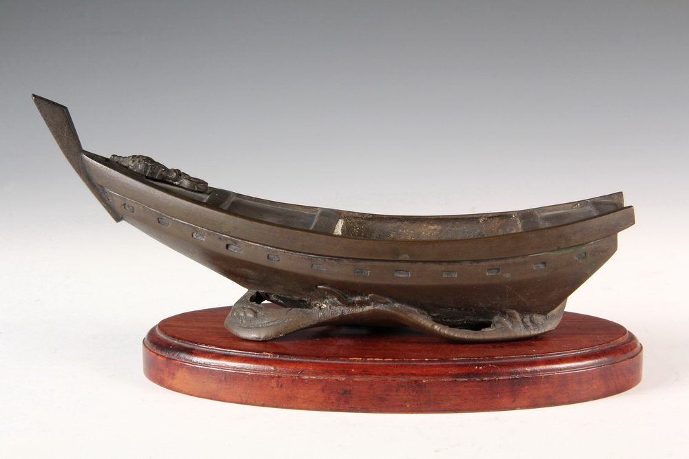 CHINESE BRONZE FIGURAL PLANTER - 19th c. Fishing Boat: CHINESE BRONZE FIGURAL PLANTER - 19th c. Fishing Boat Form Planter, with integral wave form base, set on wooden stand. 9 1/2" long. Good condition.