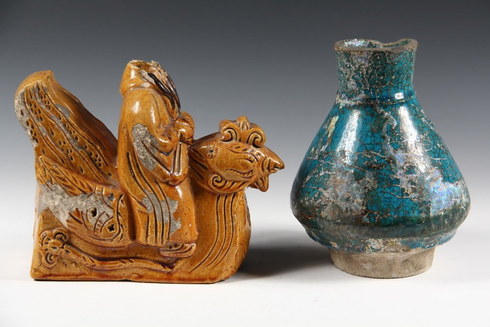 (2 PCS) CHINESE POTTERY - Han Dynasty Glazed Pottery,: (2 PCS) CHINESE POTTERY - Han Dynasty Glazed Pottery, including: Roof Gable Finial in form of a Man Astride a Rooster, 6" (15.2 cm) tall, 8 1/2" (21.6 cm) x 3 1/2" (8.9 cm), missing head, losses to gl