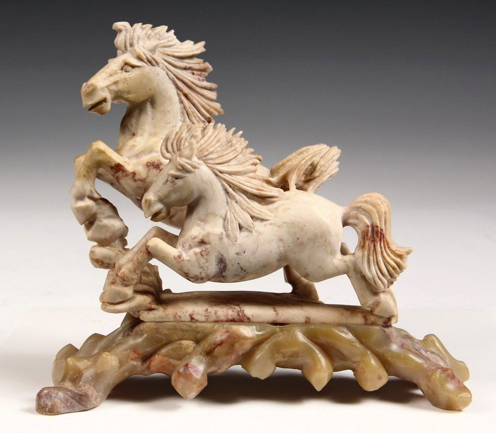 STONE SCULPTURE - Two Stallions in alabaster, set on a: STONE SCULPTURE - Two Stallions in alabaster, set on a root form jade base, probably Chinese, circa 1930s. 7" tall. Fine condition.