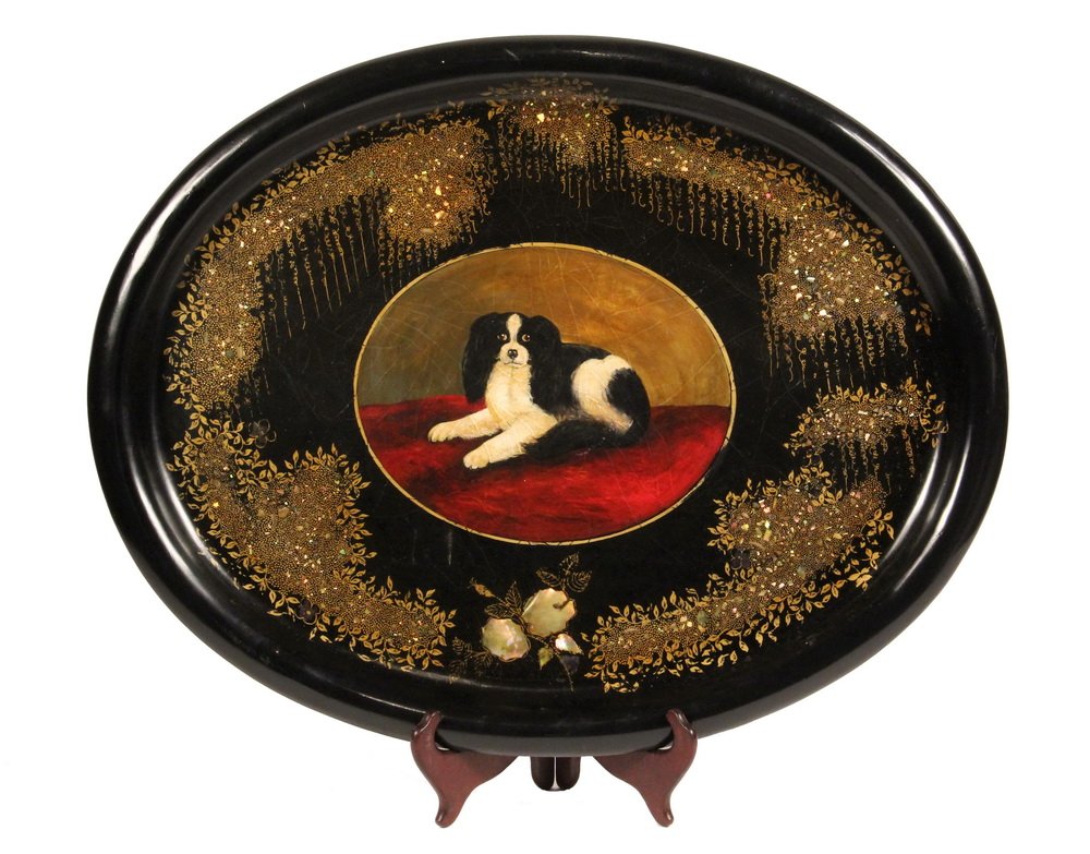 TOLE PAINTED TRAY - Large Oval Papier Mache Tray with: TOLE PAINTED TRAY - Large Oval Papier Mache Tray with rolled edge, handpainted portrait of a King Charles Spaniel Dog, surrounded by gilt vinework and mother-of-pearl inlay. 19" x 24 1/2". Repair to r