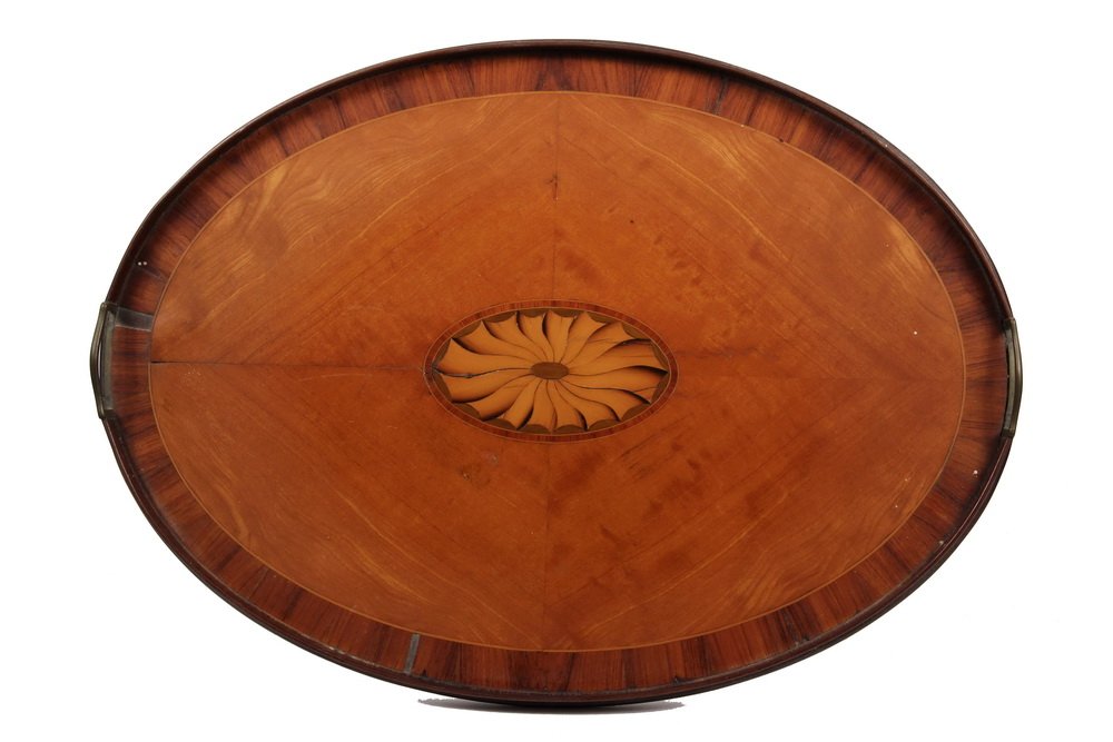 ENGLISH TEA TRAY - Early Inlaid Mahogany Oval Footed: ENGLISH TEA TRAY - Early Inlaid Mahogany Oval Footed Tray with inset brass handles, having central oval patella, banded edge. 22 1/2" x 16". Minor veneer loss, fine paint spatter to underside.
