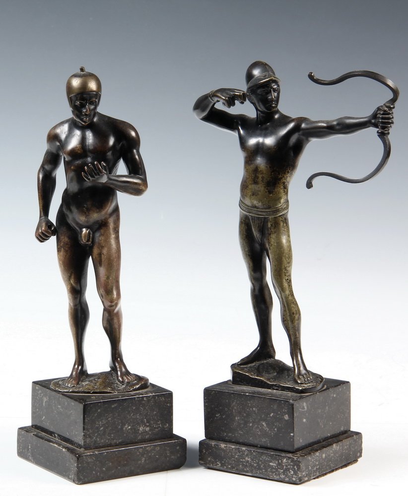 (2) BRONZE STATUES - Greek Warriors signed B.Moret, on: (2) BRONZE STATUES - Greek Warriors signed B.Moret, on matching black marble plinths, one with recurved bow, the other with hands in position to hold missing spear, both in helmets, 10" tall overall, 
