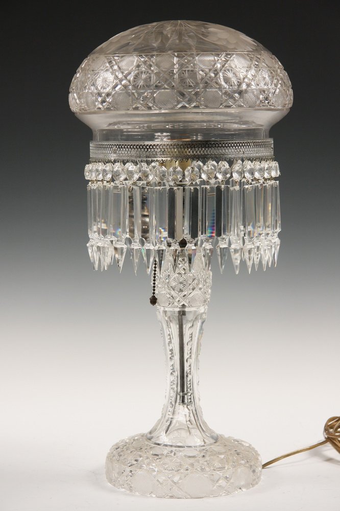 CRYSTAL PIANO LAMP - Cut Crystal Piano Lamp with: CRYSTAL PIANO LAMP - Cut Crystal Piano Lamp with classic mushroom shade set on reticulated silver painted ring with prism drops, waisted stem goes to round domed base, all in starburst cut with deeply