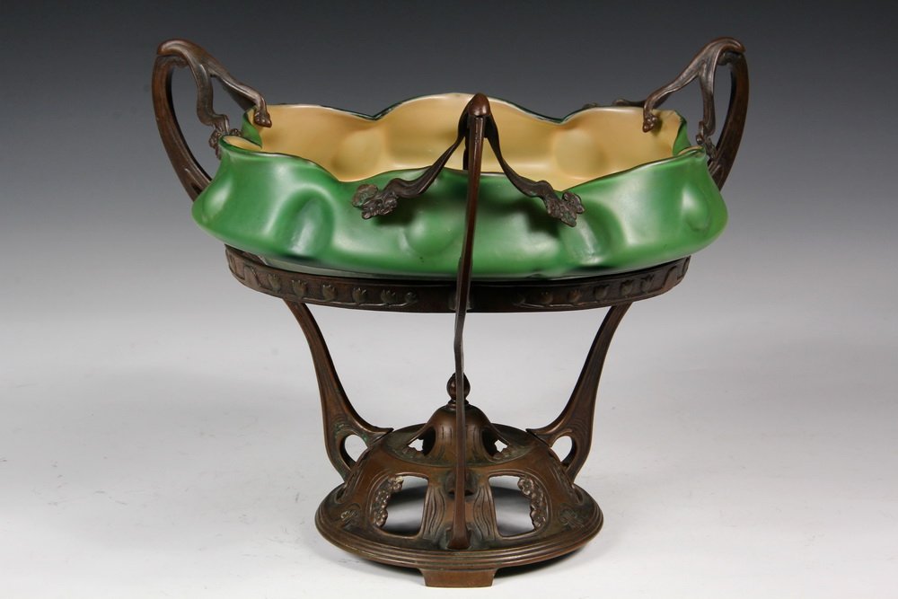 LOETZ ART GLASS CENTERPIECE - Three Stem Art Nouveau: LOETZ ART GLASS CENTERPIECE - Three Stem Art Nouveau Bronze Stand with reticulated domed base having finial, vine swags supporting pinched green bowl with caramel interior. Austrian, circa 1890. Glass