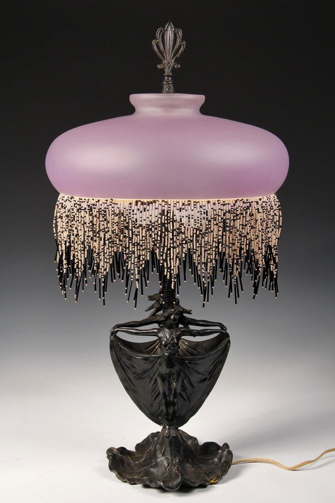 ART NOUVEAU TABLE LAMP - Black Painted Spelter Base of: ART NOUVEAU TABLE LAMP - Black Painted Spelter Base of back-to-back Isadora Duncan style dancers with large domed frosted pale lavender shade having daggered black & white glass bead fringe, palm fron
