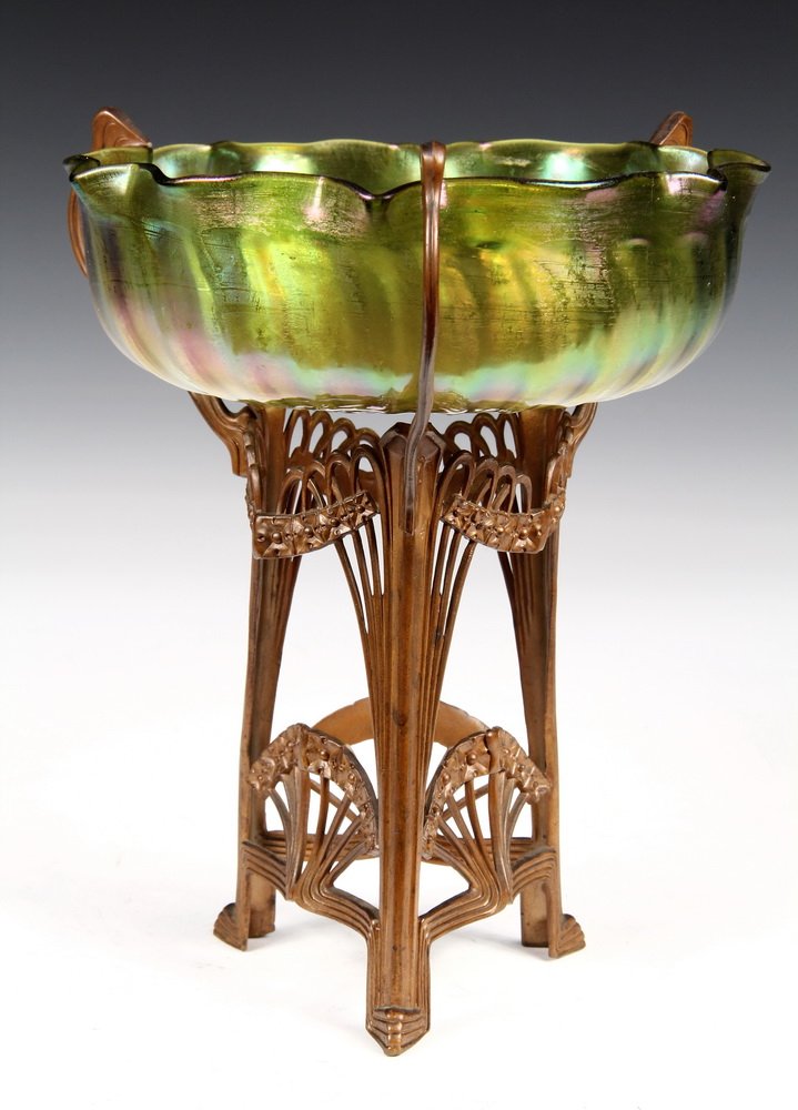 LOETZ ART GLASS COMPOTE - Jugendstihl Bronze Tripod: LOETZ ART GLASS COMPOTE - Jugendstihl Bronze Tripod Base with geometric floral forms, supporting iridescent golden green sunburst bowl with ruffled edge, ground pontil. Austrian, circa 1900. Unmarked.