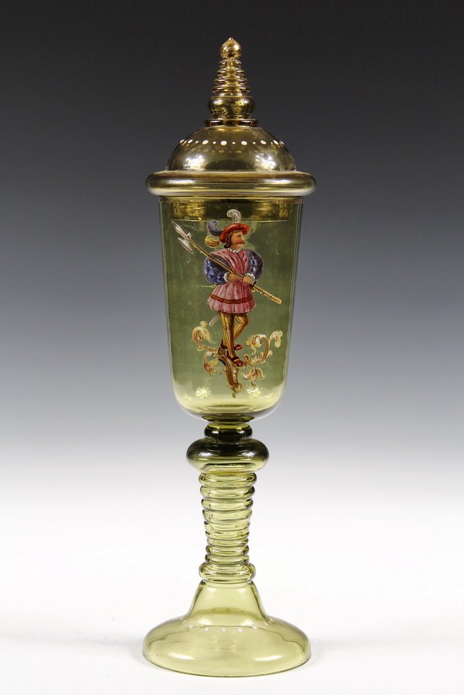 BOHEMIAN GLASS CHALICE - Theresienthal Amber Glass: BOHEMIAN GLASS CHALICE - Theresienthal Amber Glass Covered Chalice with enameled decoration of a soldier carrying a halberd, having typical ringed stem. 16 1/4" tall. Fine condition.