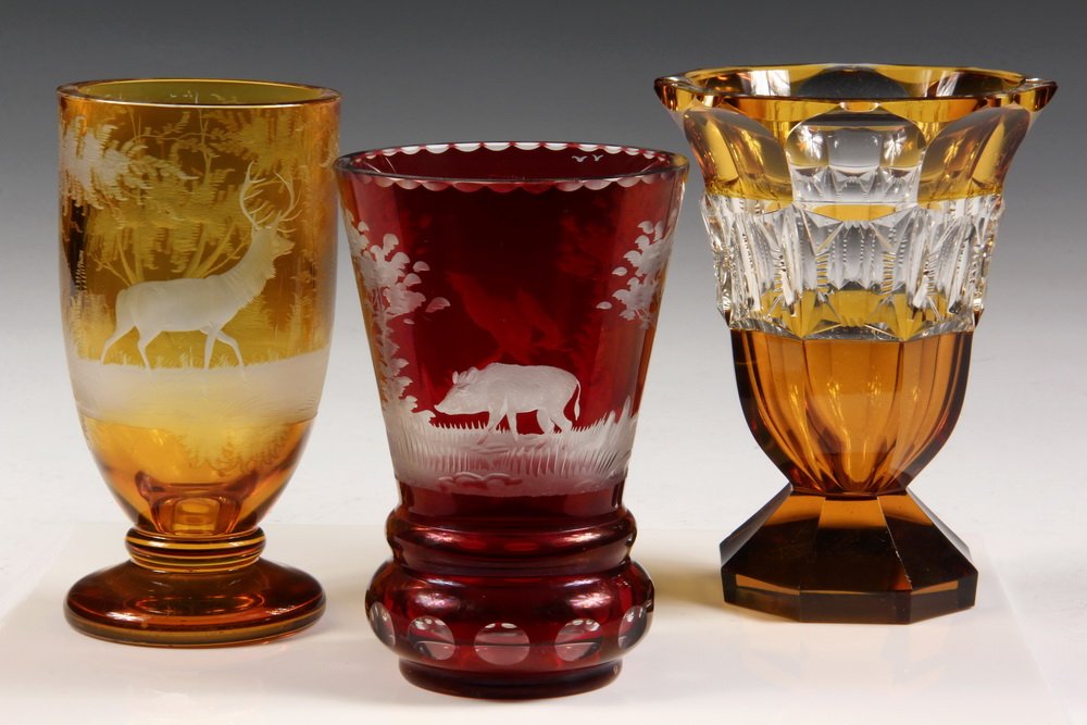 (3) ART GLASS GOBLETS / VASES - Bohemian Glass Footed: (3) ART GLASS GOBLETS / VASES - Bohemian Glass Footed Goblet w deer in forest; Red Beaker w boar & grouse; Moser Vase in faceted & cut amber / clear . 5 1/4", 5 3/4" & 6" tall. Good condition.