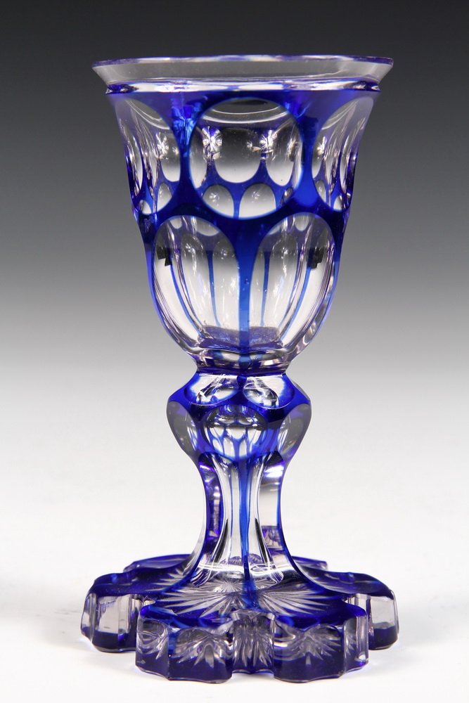 BOHEMIAN GLASS FOOTED BEAKER - Cobalt Cut to Clear: BOHEMIAN GLASS FOOTED BEAKER - Cobalt Cut to Clear Beaker with six petal starburst foot, knobbled stem. Unmarked. Circa 1840. 5 3/4" tall. Fine condition.