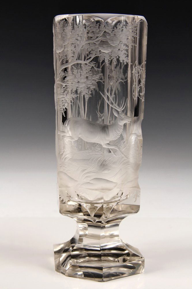 ART GLASS BEAKER - Six-Sided Thick-Walled Clear Glass: ART GLASS BEAKER - Six-Sided Thick-Walled Clear Glass Beaker, with deep intaglio cut & etched view of deer in forest, monogram of 'WS' at center, on stemmed foot. Probably Austrian, circa 1880. 9" tal