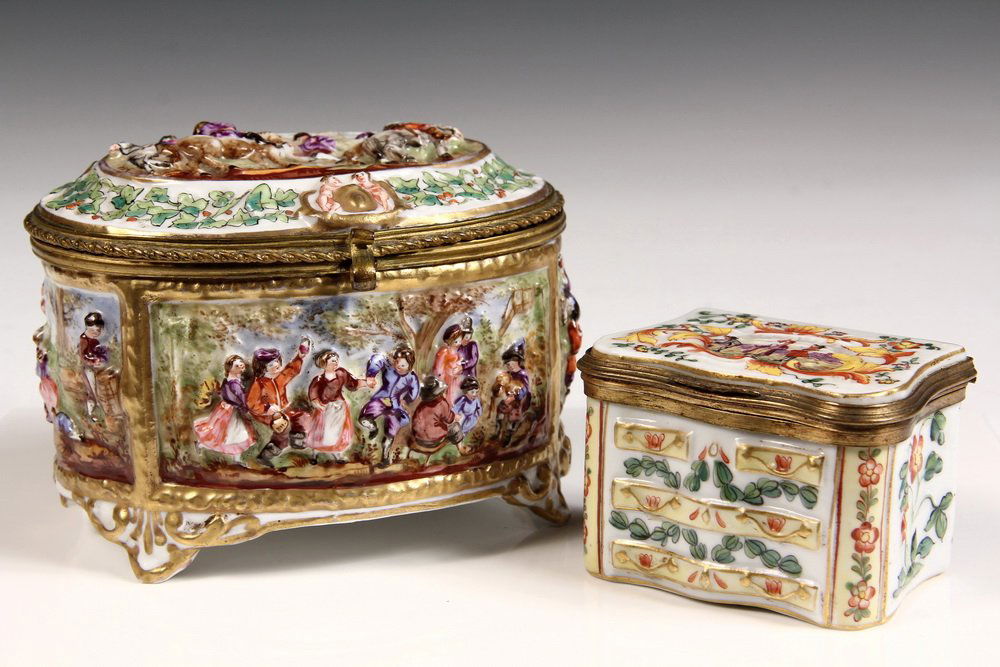 (2) PORCELAIN JEWEL BOXES - Capodimonte, with gilt: (2) PORCELAIN JEWEL BOXES - Capodimonte, with gilt bronze fittings, 19th c: Oval Box with relief decoration of men on horseback on lid, country dances on sides; PLUS Dresser Form with Turks on top. 3