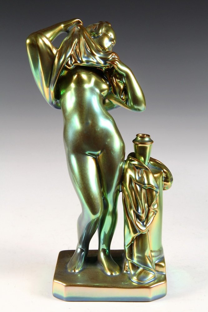 ZSOLNAY PECS EOSIN PORCELAIN - Standing Figure of Woman: ZSOLNAY PECS EOSIN PORCELAIN - Standing Figure of Woman Disrobing next to pedestal, 1930s vintage. Factory established by Miklos Zsolnay (1800-1880), in Pecs, Hungary. 10 1/4" tall. Fine condition.