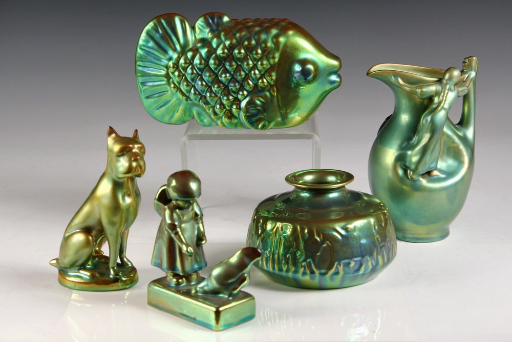(5) ZSOLNAY PECS EOSIN PORCELAIN - Inc: Small Pitcher: (5) ZSOLNAY PECS EOSIN PORCELAIN - Inc: Small Pitcher with figures of two women; Figure of a Boxer Dog; Figure of Girl Feeding Chicken; Figure of Fish & Low Vase with frieze of Greek soldiers. 1930s-5