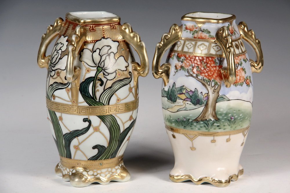 (2) SIMILAR NIPPON PORCELAIN VASES - Four-Handled Vases: (2) SIMILAR NIPPON PORCELAIN VASES - Four-Handled Vases in the same shape, ovoid with square mouth, shaped foot & wave-form handles, with different decoration: one floral, one landscape, with gilt mor