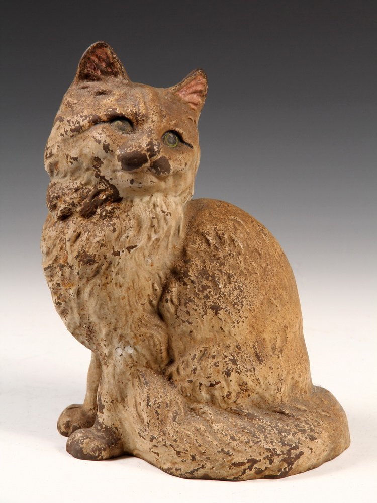 FIGURAL CAST IRON DOORSTOP - Fully Dimensional: FIGURAL CAST IRON DOORSTOP - Fully Dimensional Realistic Seated Cat in remnants of white paint, with blue eyes. Unmarked, ca 1910. 9 1/4" tall. Losses to paint, some corrosion.