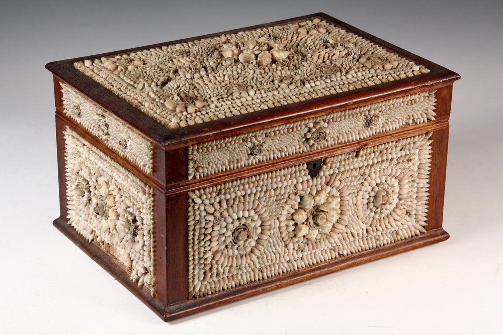 FOLK ART SHELL BOX - Victorian Shell Encrusted Box with: FOLK ART SHELL BOX - Victorian Shell Encrusted Box with mahogany frame, overall repeating designs of raised circles within squares, molded edging, lock escutcheon, red napped interior. Possibly sailor