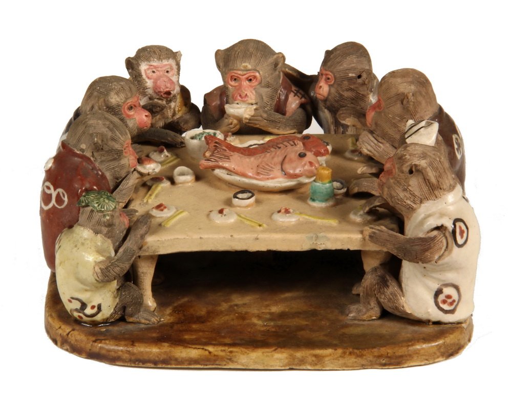 POTTERY FIGURAL GROUP - Vantines Doroyaki Japanese: POTTERY FIGURAL GROUP - Vantines Doroyaki Japanese Sculpture of Nine Monkeys having a fish feast, all dressed in traditional Nippon robes. Paper label on underside. Circa 1910. 3" x 6 1/4" square. Goo