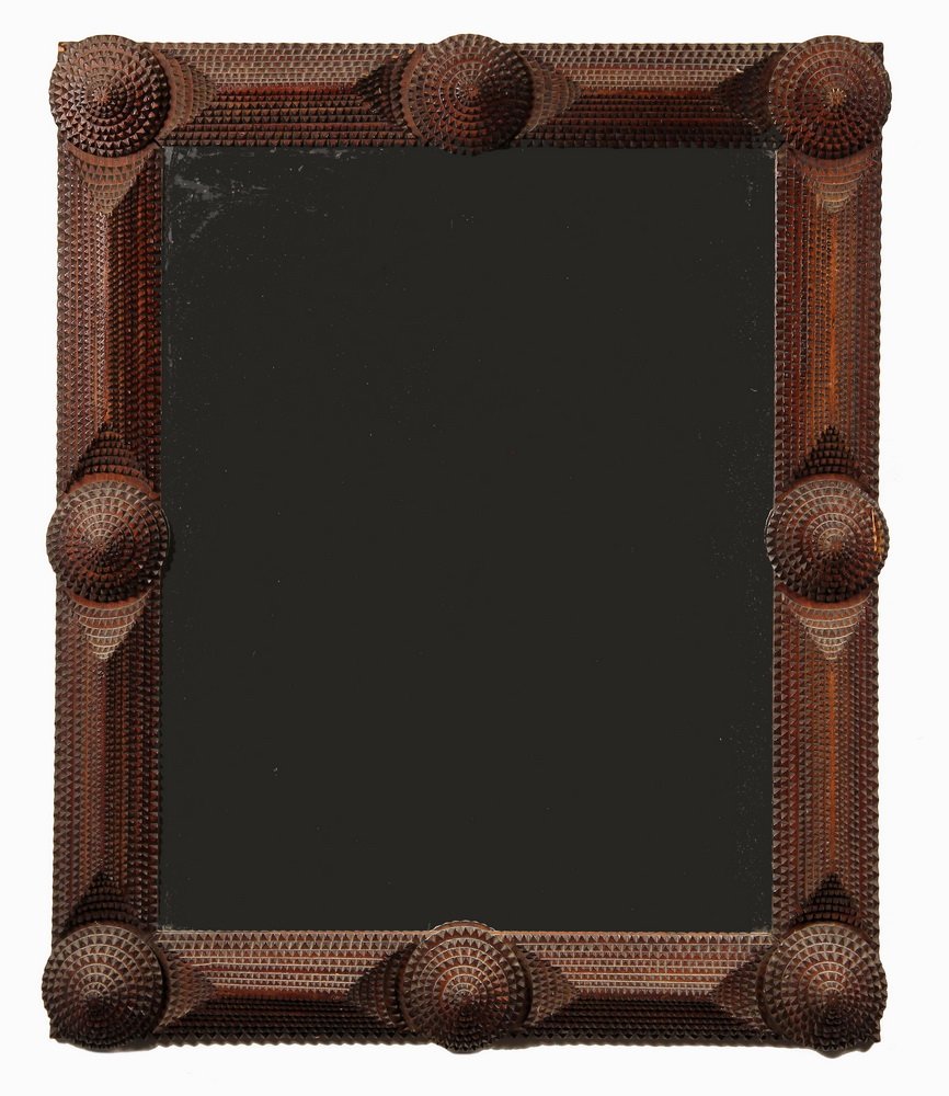 TRAMP ART FRAMED MIRROR - Circa 1910 Mahogany Frame: TRAMP ART FRAMED MIRROR - Circa 1910 Mahogany Frame with stacked pyramid and cone design, natural finish, made from old cigar boxes. 34" x 28". One bit of a corner off.