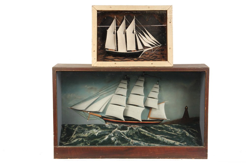 (2) SHADOWBOX SHIP MODELS - Three-Masted Barque passing: (2) SHADOWBOX SHIP MODELS - Three-Masted Barque passing a lighthouse at dusk, with dimensional sea, in brown painted case, 15" x 25 1/2" x 7 1/4"; PLUS Three-Masted Schooner in crudely painted flat su