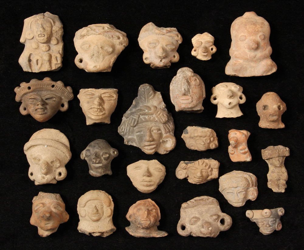 PRE-COLUMBIAN POTTERY - (24) Terra Cotta Head Fragments: PRE-COLUMBIAN POTTERY - (24) Terra Cotta Head Fragments from votive figures, most appear to be Mayan, Teotihuacan, or ChichÃ©n ItzÃ¡ area of the Yucatan Peninsula. Roughly 1" to 3".