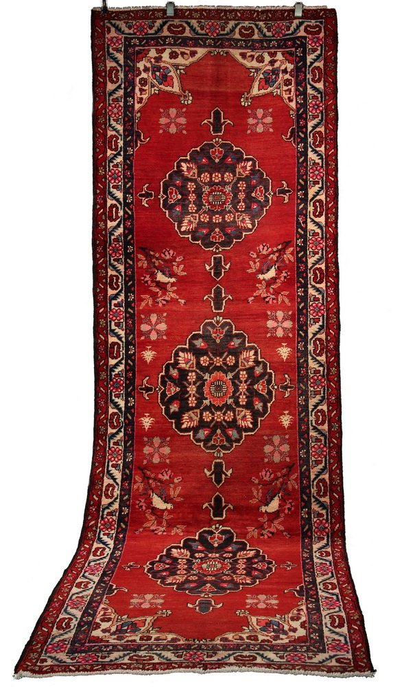 KAZAK RUNNER - 3'10" x 11'3" - Southwest Caucasus, late: KAZAK RUNNER - 3'10" x 11'3" - Southwest Caucasus, late 20th c, three circular lobed medallions in navy blue, ivory and red, set on a floral decorated red field, ivory rosette meandering border. Good 