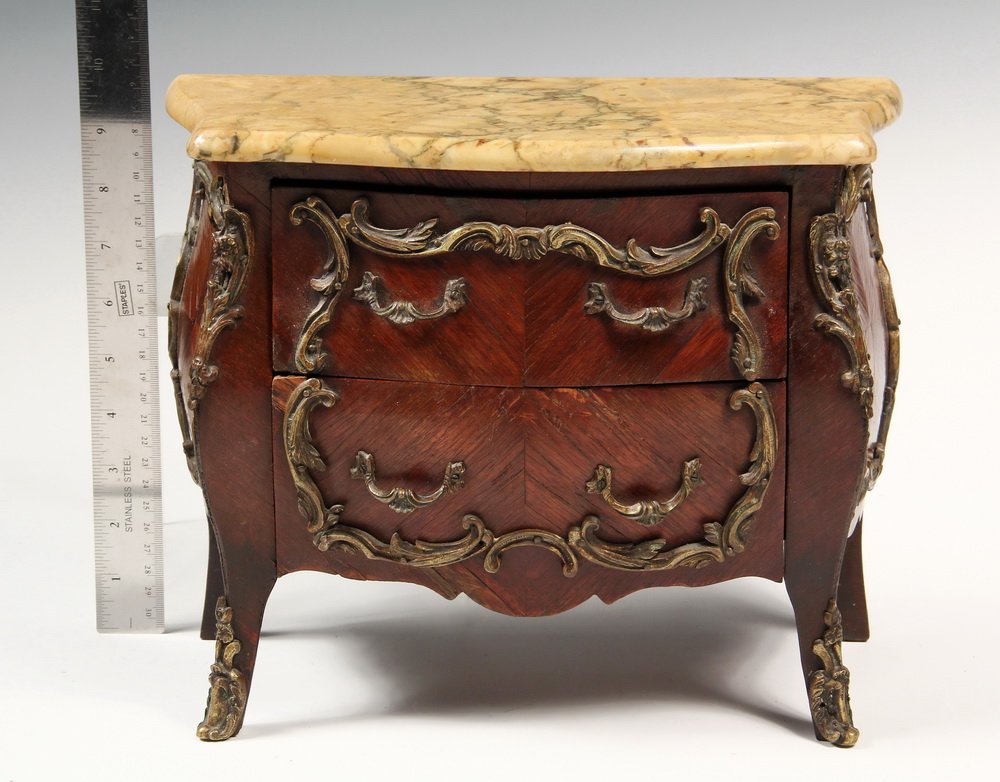 MINIATURE CHEST - French two-drawer bombe chest in: MINIATURE CHEST - French two-drawer bombe chest in fruitwood veneer with ormolu mounts, variegated ochre marble top, velvet lining. Late 19th c. 10" x 12 1/2" x 6". Minor veneer loss to lower drawer.