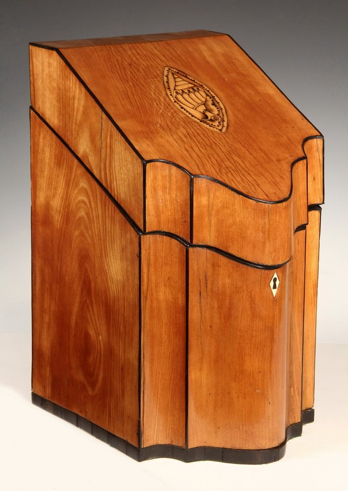 ENGLISH KNIFE BOX - Early Satinwood Slantfront Case: ENGLISH KNIFE BOX - Early Satinwood Slantfront Case with ebony stringing, oval conch shell patera on lid, fitted interior. 15 3/4" x 10 1/2" x 8 3/4". Shrinkage cracks.