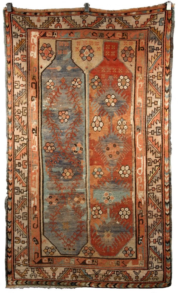 KAZAK RUG - 4'2" x 6'9" - Southwest Caucasus, late 19th: KAZAK RUG - 4'2" x 6'9" - Southwest Caucasus, late 19th c, two columns of palmettes, rosettes and latch-hooks in red, ivory, peach and blue-green, beige serrated leaf and 'wine cup' border. Selvage mi