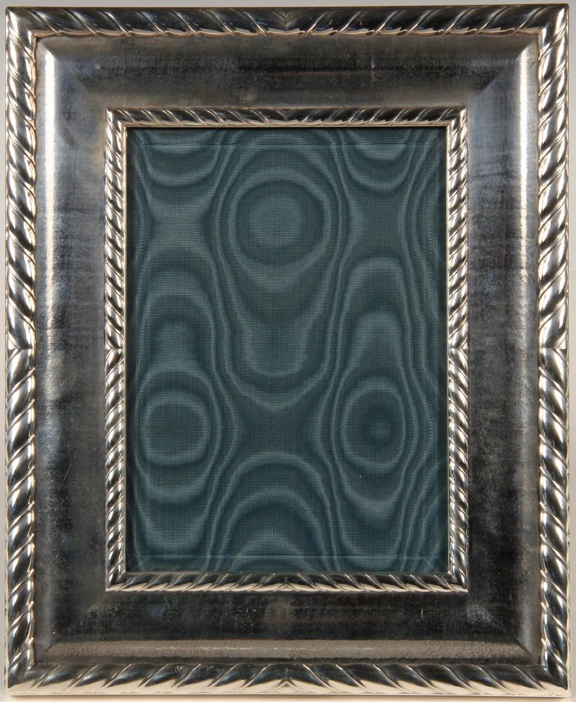 SILVER PICTURE FRAME - Sterling Silver Picture Frame by: SILVER PICTURE FRAME - Sterling Silver Picture Frame by Buccellati in the Torchon pattern, made in Italy, with beveled glass, leather back and sterling closure rosettes. SS: 5" x 7", OS: 9" x 11" Fine