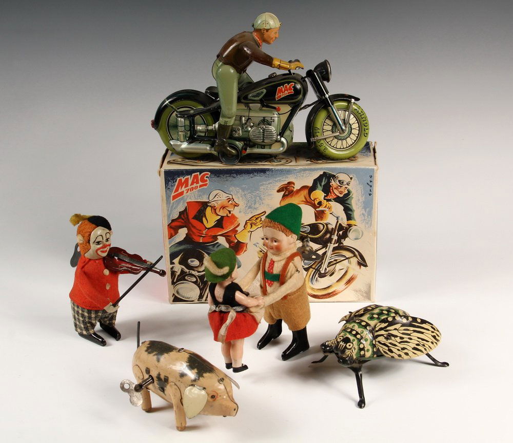 (5) GERMAN TIN KEY-WIND TOYS - Including: Schuco: (5) GERMAN TIN KEY-WIND TOYS - Including: Schuco Dancing Girl & Boy; Schuco Violin Player; Pig marked US Zone; Unmarked Walking Beetle; Arnold Mag 700 Motorcycle in box. Generally good condition.One a