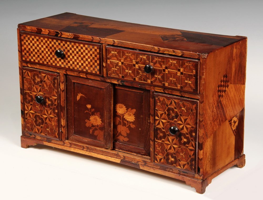 FOLK ART MINIATURE CABINET - Inlaid Credenza Form: FOLK ART MINIATURE CABINET - Inlaid Credenza Form Tabletop Trinket Box with overall asymetrical geometric decoration in the Japanese manner, floral sliding drawers, four drawers. Circa 1875, aesthetic