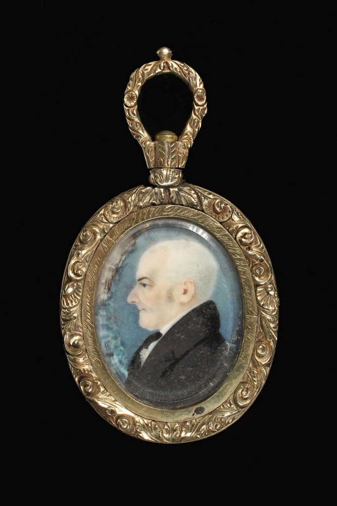 PAIR OF MINIATURES IN PENDANT - Oval Watercolor on: PAIR OF MINIATURES IN PENDANT - Oval Watercolor on Ivory Portraits of an Elderly Couple set in a gold floral mount with swivel loop, engraved "John Frame, born 18th Jany 1770, died 15th Jany 1843, age